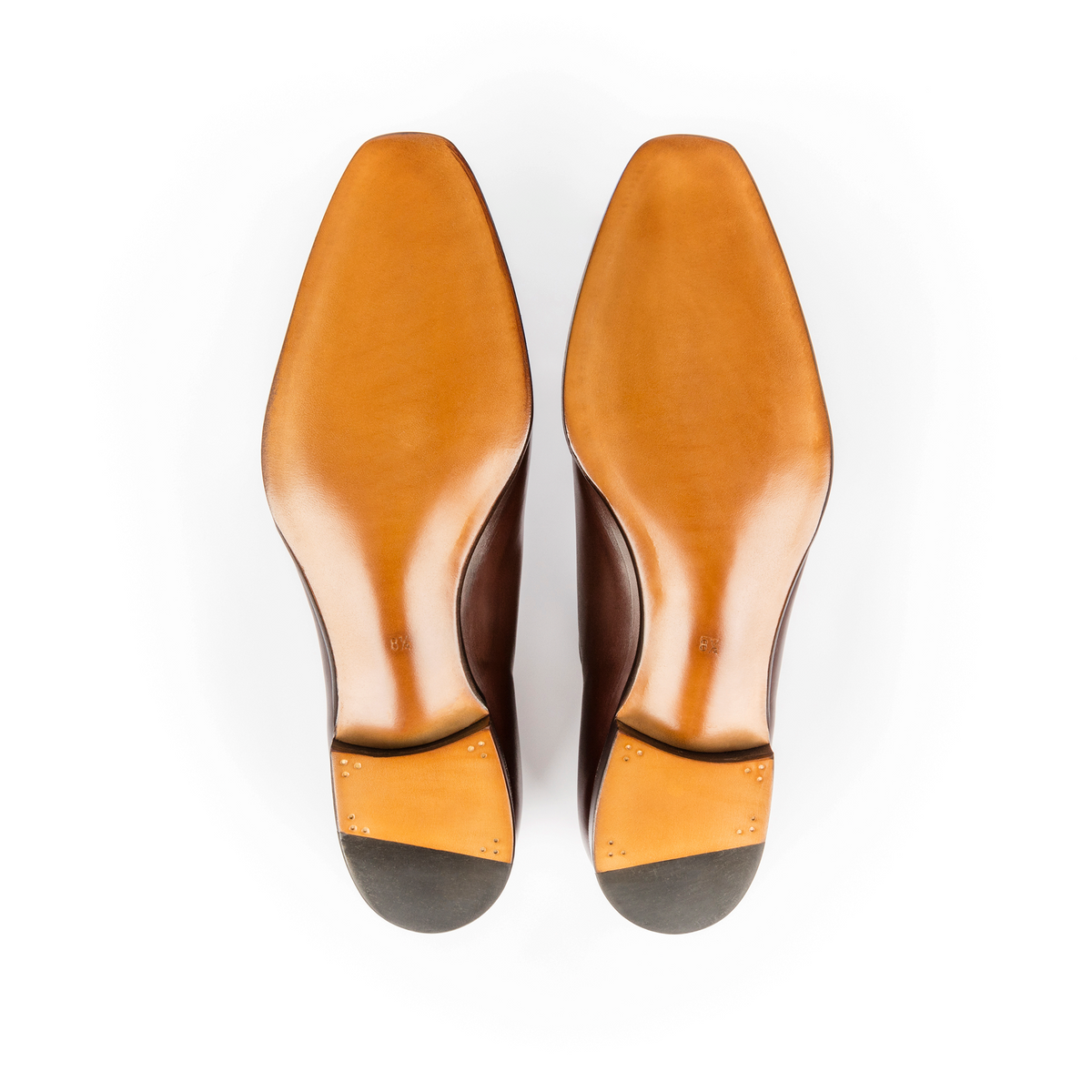 TLB Mallorca 144 Artista tassel loafers showing the smooth tan leather soles and stacked heels from a bottom view
